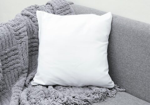 white throw pillow on gray sofa