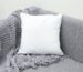white throw pillow on gray sofa